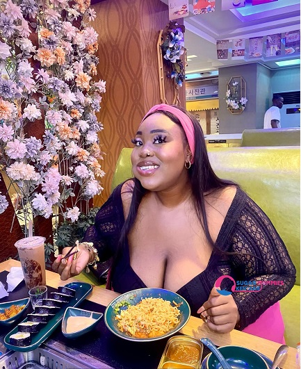 Beautiful Malindi sugar mummy Bridget smiling in a tropical setting